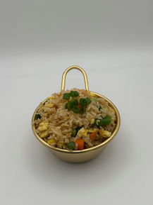Fried rice with egg, peas, carrots, and green onions in a gold bowl