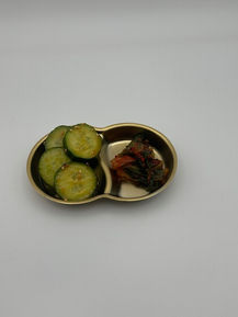 Pickled cucumbers and kimchi in a small dish