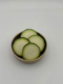 Green gourd slices in a bowl