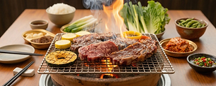 Steaks and vegetables grilling over open flames